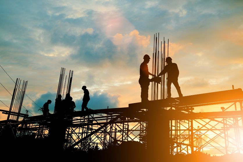 the image shows a group of construction workers at a construction job site.
